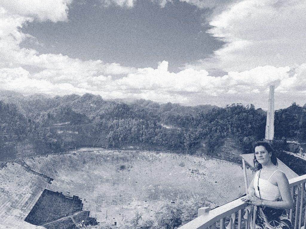 Raquel Velho standing on the observation deck overlooking the collapsed Arecibo Observatory dish, Puerto Rico.